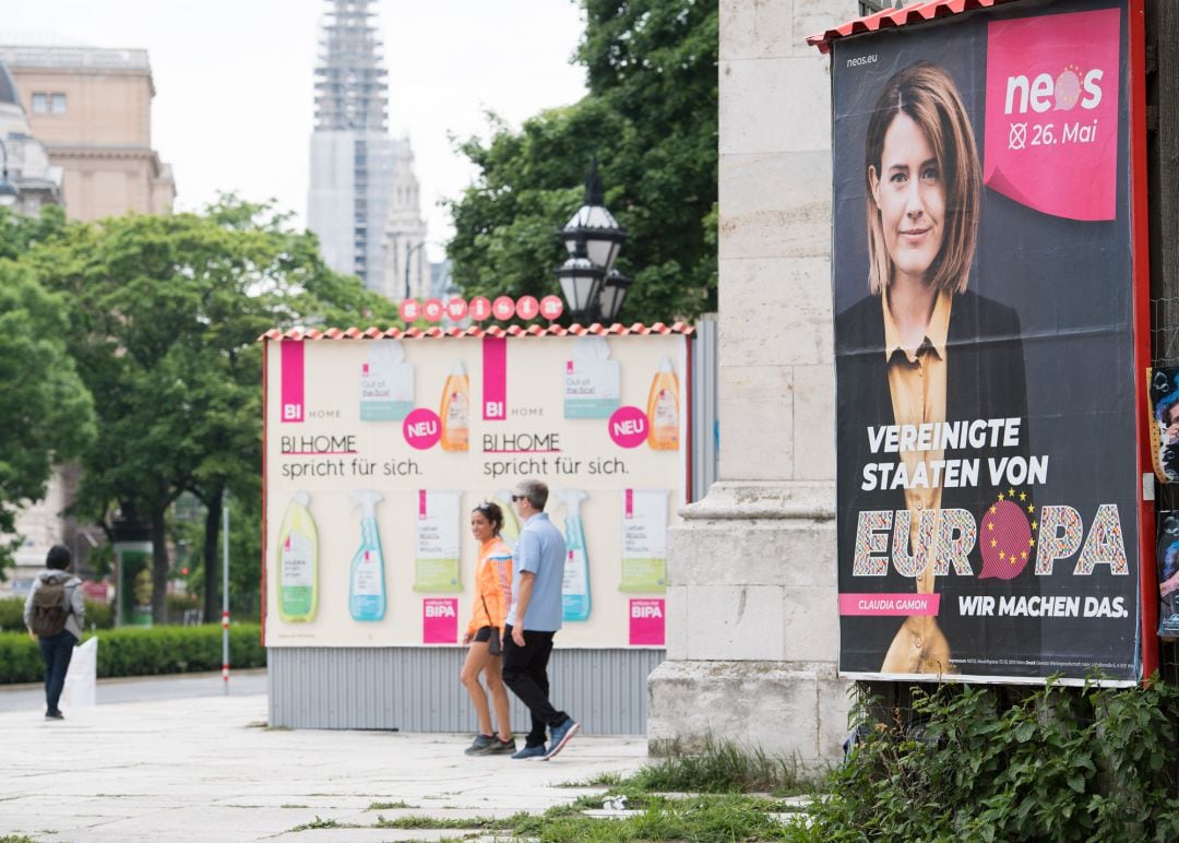 VIENNA, AUSTRIA - MAY 19: People walk past election campaign posters of the NEOS party during the &quot;One Europe For All&quot; march on May 19, 2019 in Vienna, Austria. Thousands of people are marching in similar events in cities across Europe today to voice their opposition against right-wing nationalism and populism ahead of European parliamentary elections scheduled for May 23-26.