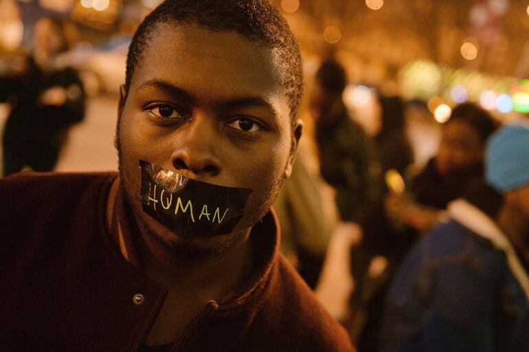 Protestors demonstrate during a silent protest in the streets of downtown St. Louis, Missouri on March 14, 2015. Ferguson, Missouri hit the headlines in August when a white policeman fatally shot unarmed black teenager Michael Brown, setting off protests that spread to major cities across the United States and triggered a national debate about police tactics, especially in relation to African Americans. AFP PHOTO / MICHAEL B. THOMAS