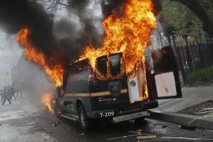 A Baltimore Metropolitan Police transport vehicle burns during clashes in Baltimore, Maryland April 27, 2015. Maryland Governor Larry Hogan declared a state of emergency and activated the National Guard to address the violence in Baltimore, his office sai