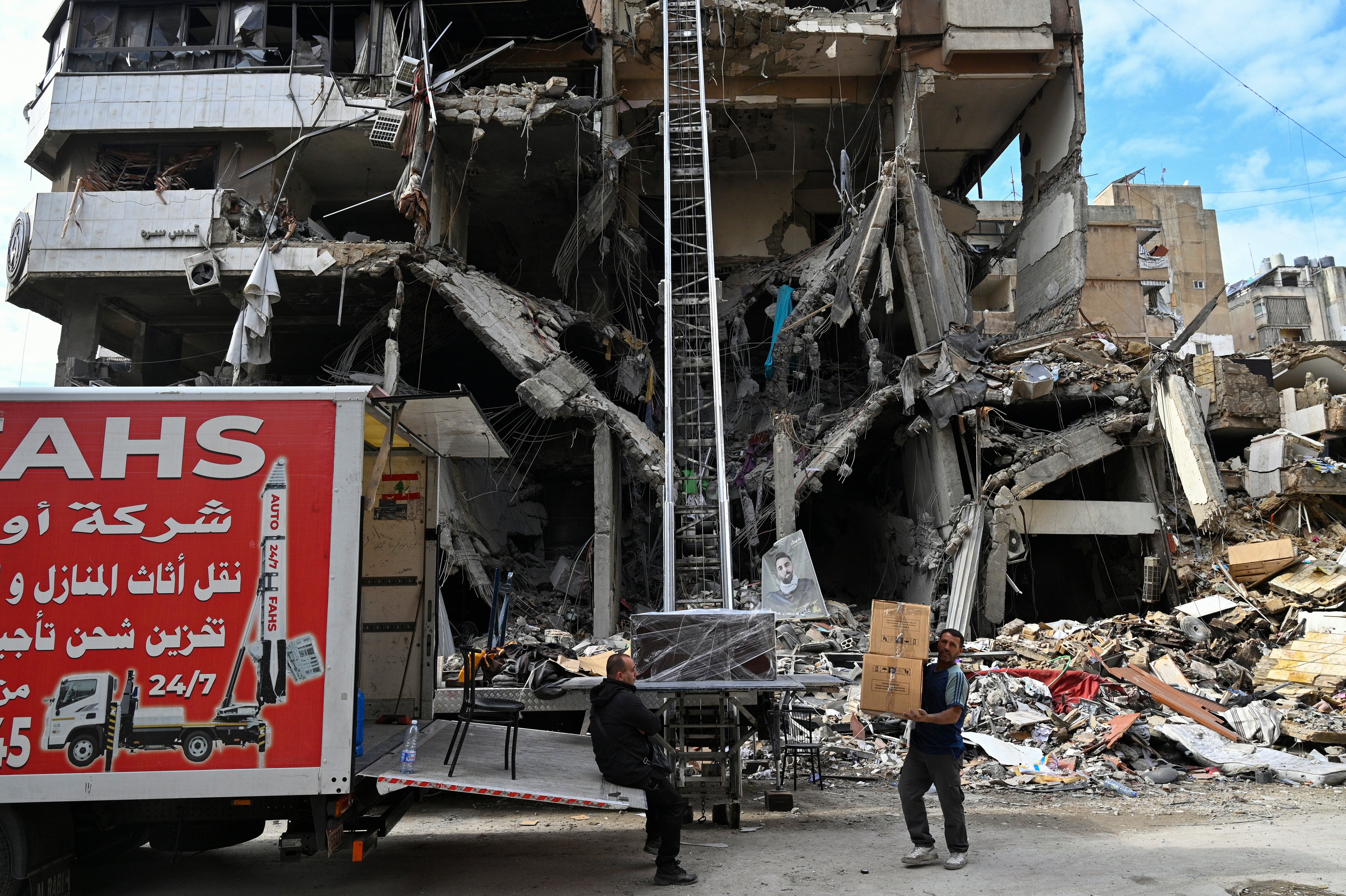 Workers move furniture from a damaged building as displaced residents return following a ceasefire deal in Dahieh, southern Beirut, Lebanon, 29 November 2024. A 60-day ceasefire agreement between Israel and Hezbollah came into force on 27 November. (Líbano, Hizbulá/Hezbolá) EFE/EPA/WAEL HAMZEH