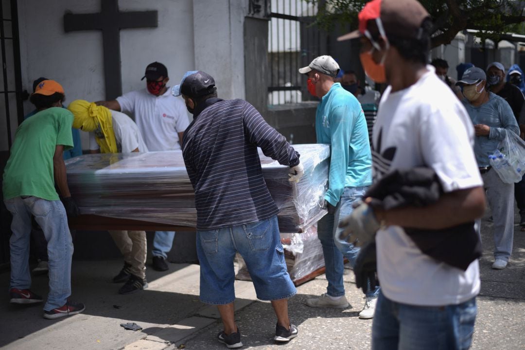  vecinos llevan un feretro dentro del cementerio de Guayaquil, en Ecuador. 