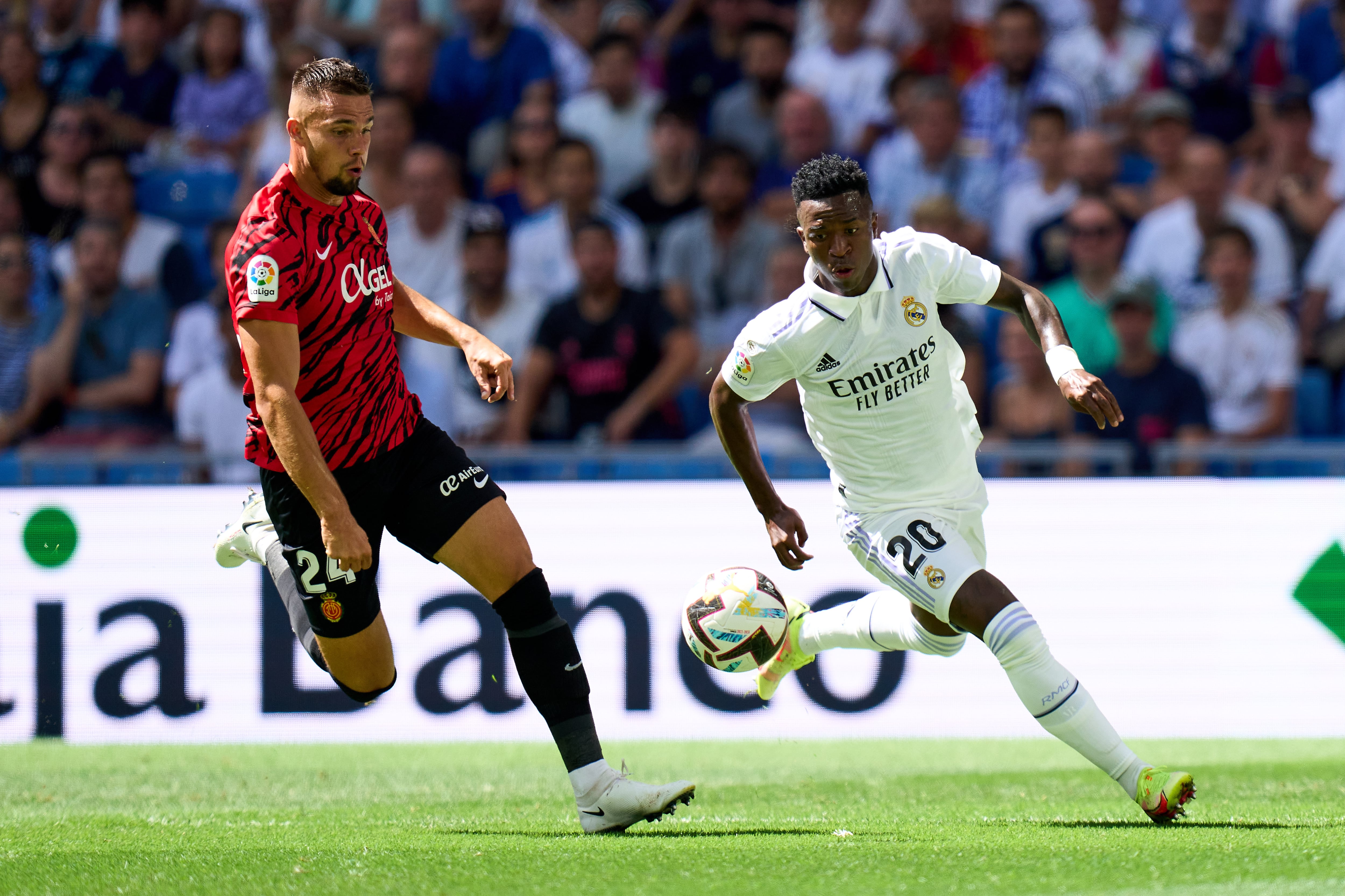 MADRID, SPAIN - SEPTEMBER 11: Vinicius Junior of Real Madrid CF is challenged by Martin Valjent of RCD Mallorca during the LaLiga Santander match between Real Madrid CF and RCD Mallorca at Estadio Santiago Bernabeu on September 11, 2022 in Madrid, Spain. (Photo by Angel Martinez/Getty Images)