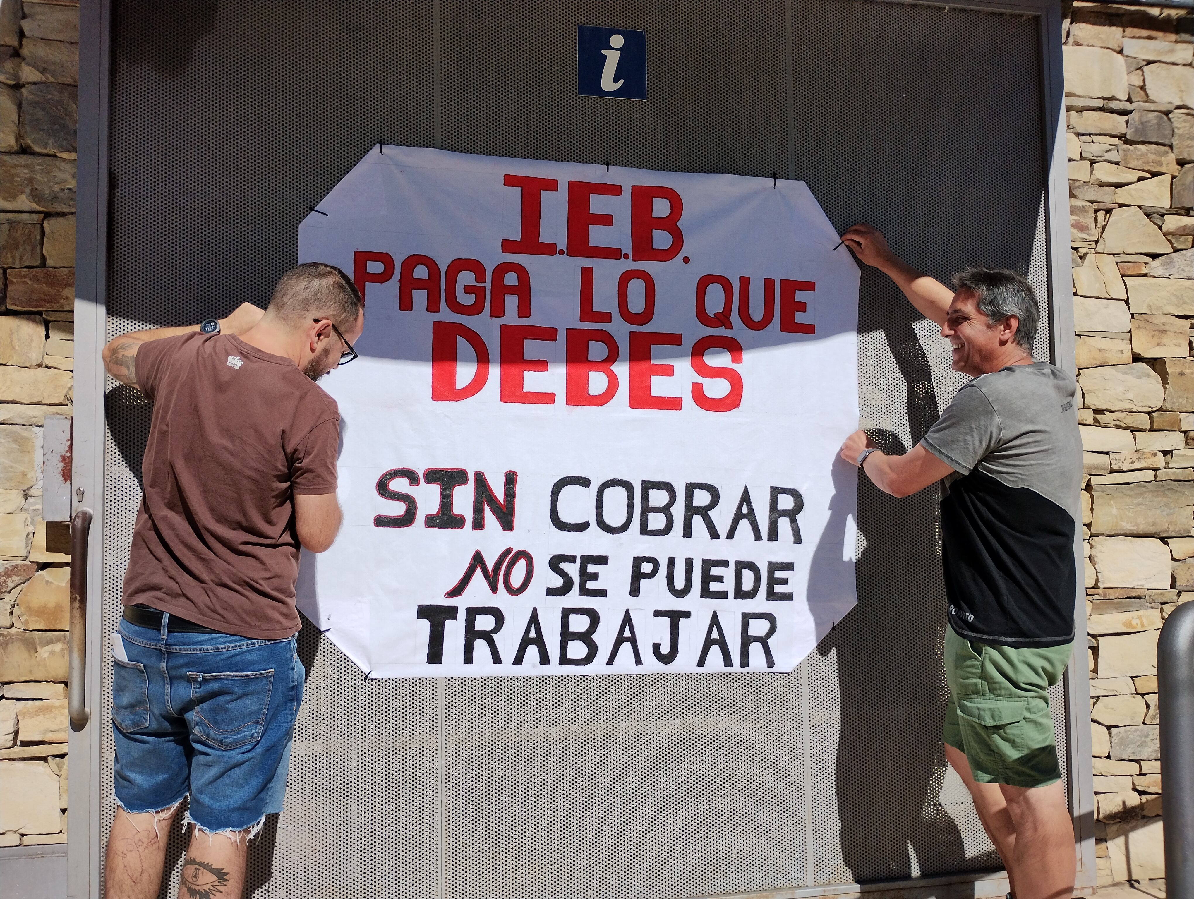 Los empleados despliegan una pancarta en el aula arqueológica de las Médulas