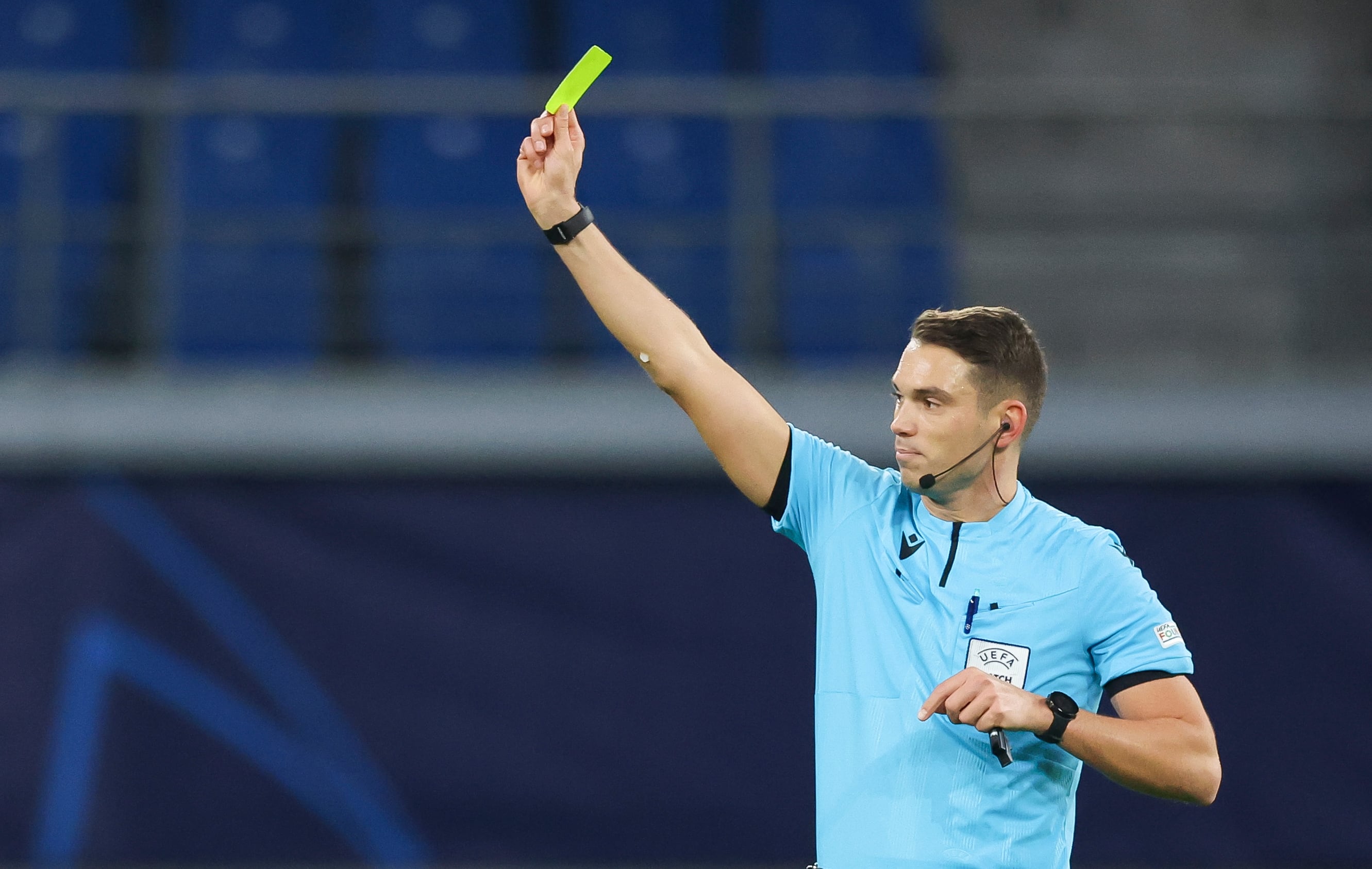 07 December 2021, Saxony, Leipzig: Football, Champions League, RB Leipzig - Manchester City, Group stage, Group A, Matchday 6 at Red Bull Arena. Referee Sandro Schärer shows the yellow card. Photo: Jan Woitas/dpa-Zentralbild/dpa (Photo by Jan Woitas/picture alliance via Getty Images)