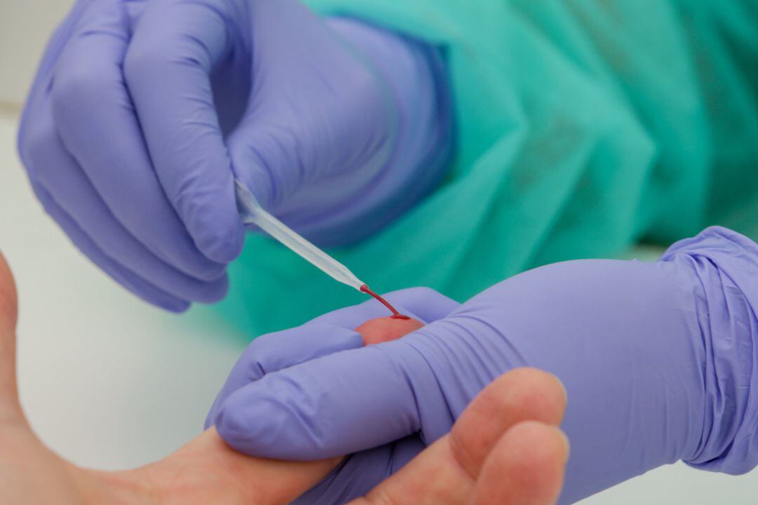 Una trabajadora sanitaria totalmente protegida, realiza una prueba diagnóstica del coronavirus.