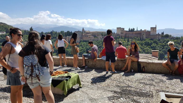 Turistas en Granada el pasado mes de septiembre con la Alhambra al fondo desde el Mirador de San Nicolás, en el Albaicín