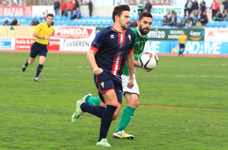 Joselu controla un balón ante la mirada de un rival.