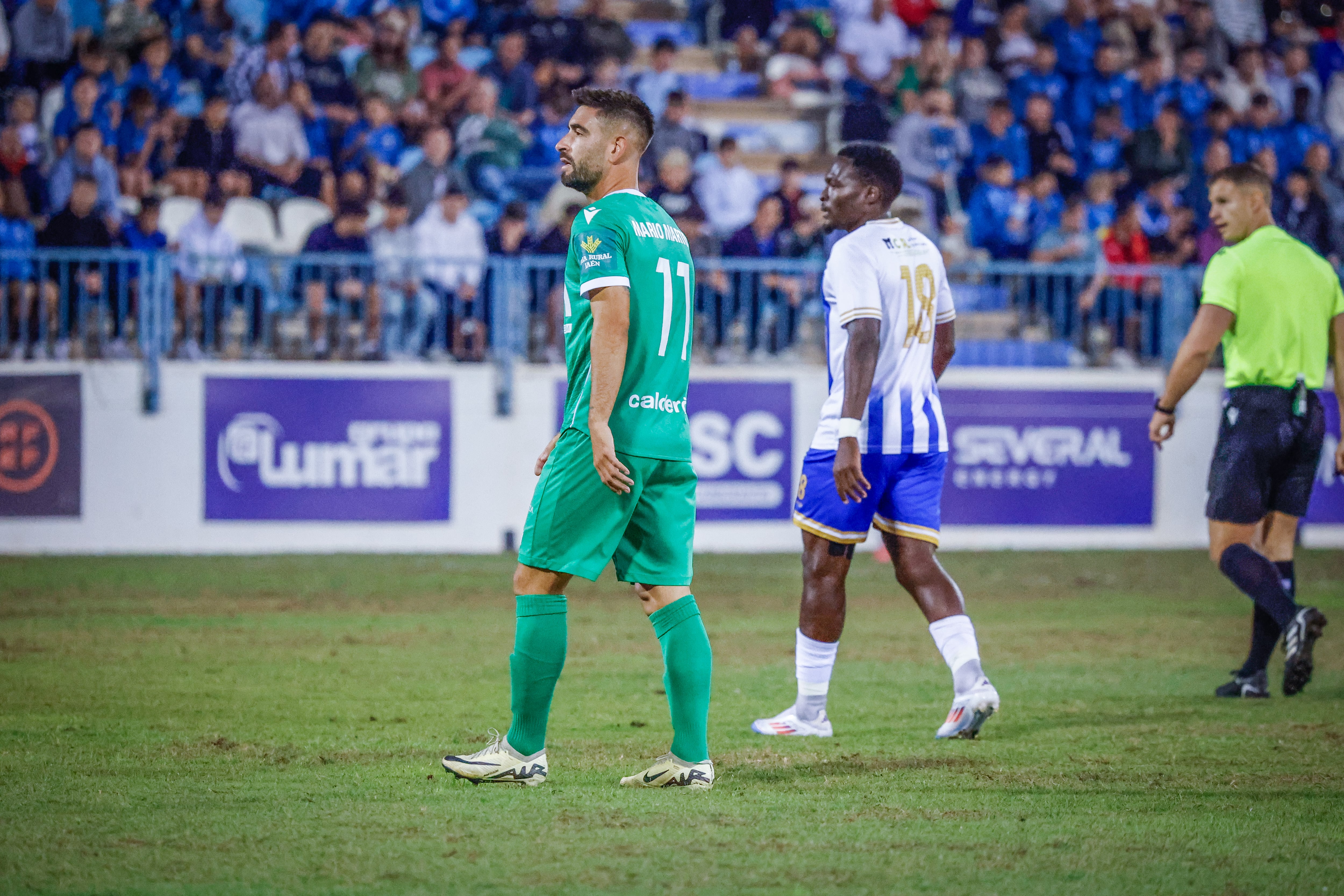 Mario Martos, jugador del Real Jaén, en primer plano junto a Baka, futbolista del CF Motril.