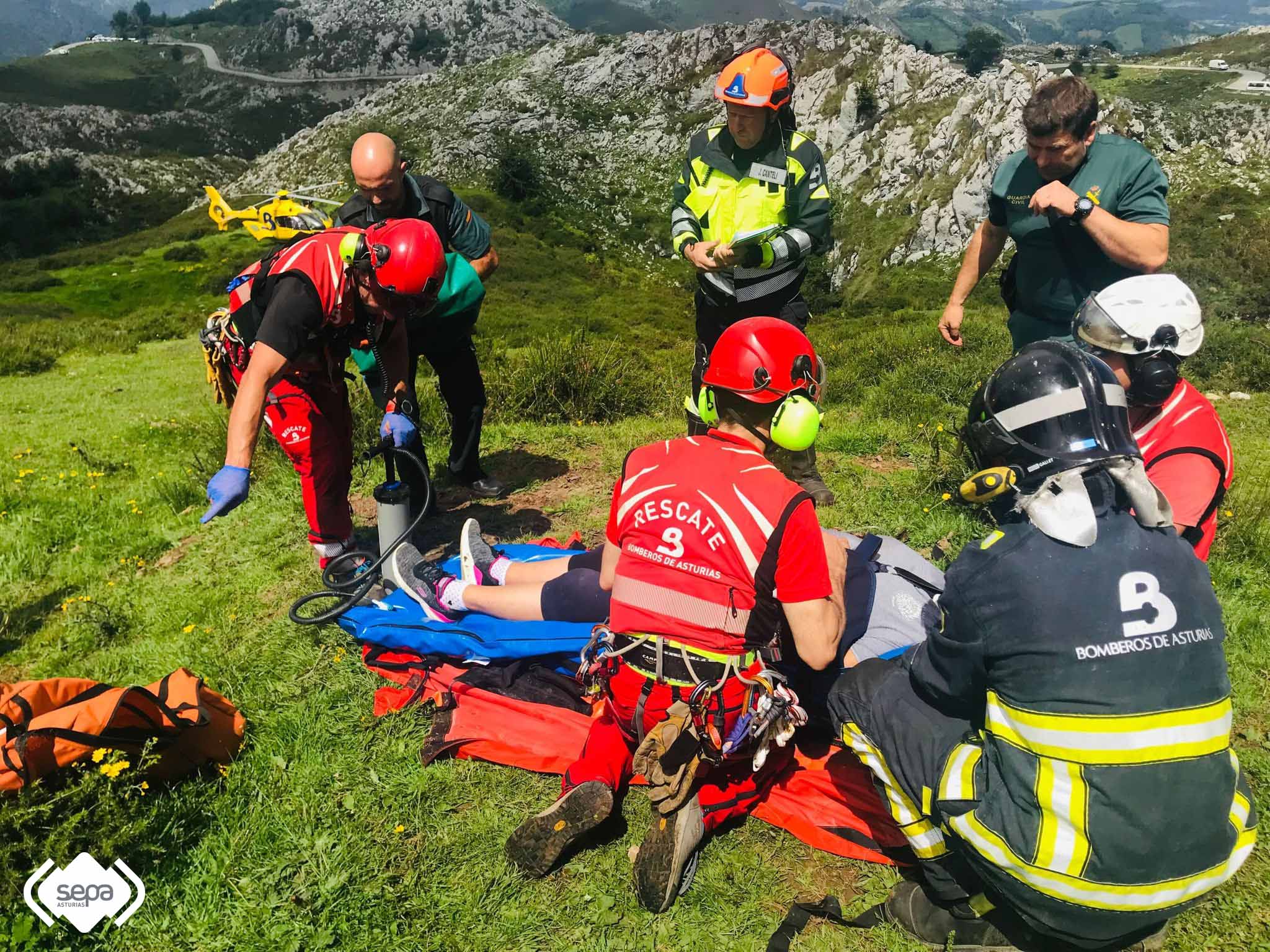 Los equipos de rescate atienden a un herido en el accidente de un autobús en la carretera de los Lagos de Covadonga