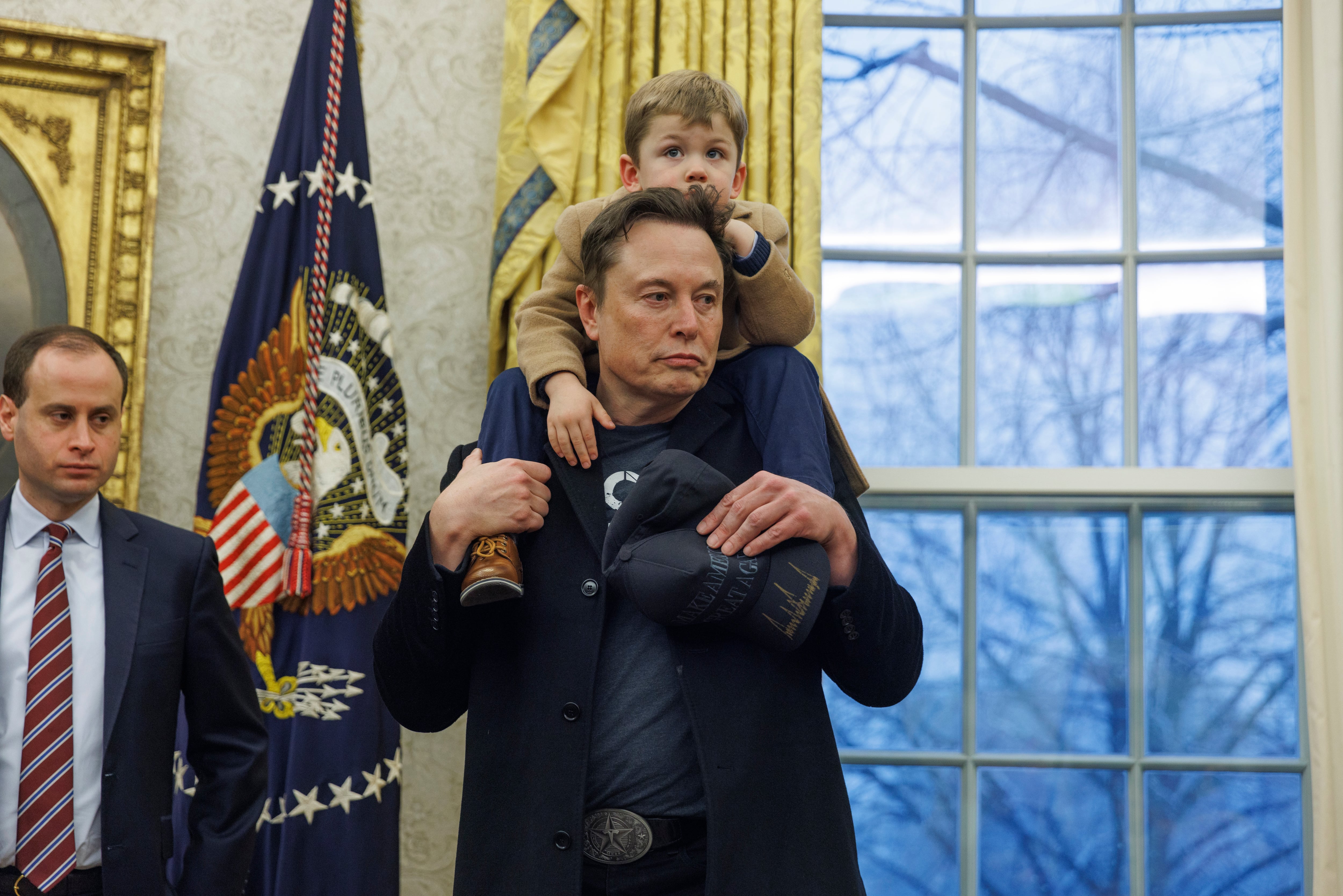 El magnate Elon Musk, con su hijo a hombros, en el despacho oval de la Casa Blanca acompañando a Donald Trump en la firma de un decreto