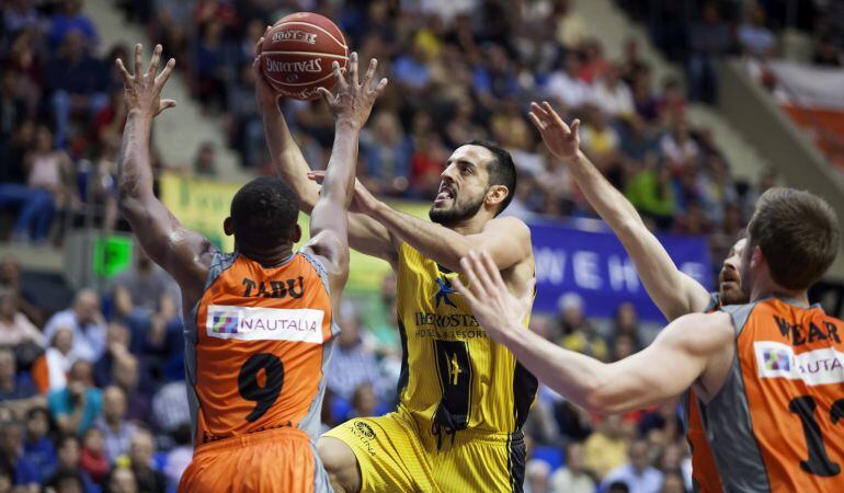 El escolta del Iberostar Tenerife Salva Arco (c) entra a canasta ante la oposición del base del Montakit Fuenlabrada Jonathan Tabu (i), durante el partido de la 28ª jornada de la Liga ACB en el pabellón Santiago Martín de La Laguna (Tenerife).