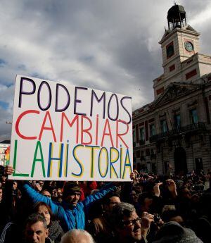 MADRID, SPAIN - JANUARY 31: A Podemos party supporter holds a placard reading &#039;We can change the history&#039; at the end of a march on January 31, 2015 in Madrid, Spain. According to the last opinion polls Podemos (We Can), the anti-austerity left-wing party 