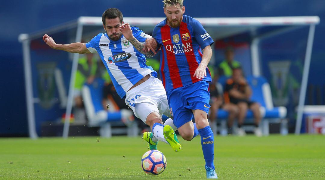 Lionel Messi (d) y Pablo Insua durante el partido que C.D. Leganés y F.C. Barcelona disputaron en Butarque en la temporada 2016-2017