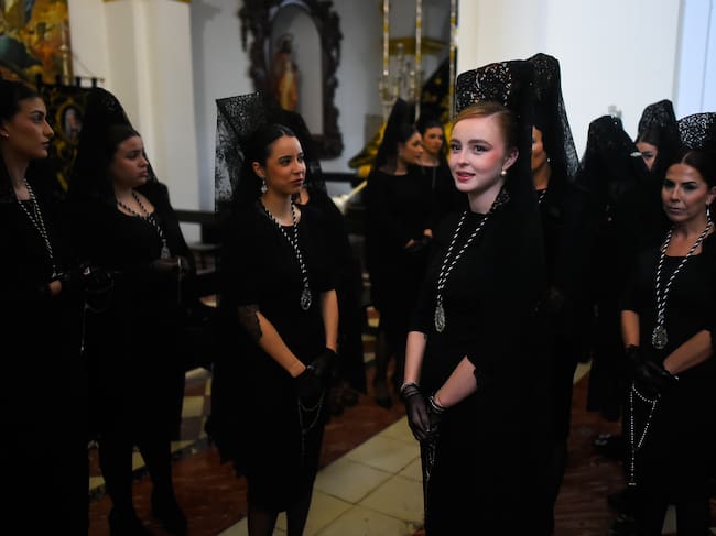 MALAGA, SPAIN - 2026/03/31: Women wearing traditional "mantilla" (mourning clothes) from 'Humillacion y estrella' brotherhood, are seen waiting inside the church as they take part in a procession on Holy Tuesday to mark the Holy Week celebrations. Thousands of worshippers wait to see the processions with the statues of Christ and the Virgin Mary as part of the traditional Holy Week celebrations. In Andalusia, Easter brings together thousands of people from all over the world and it's considered one of the most important religious and cultural events of the year. (Photo by Jesus Merida/SOPA Images/LightRocket via Getty Images)