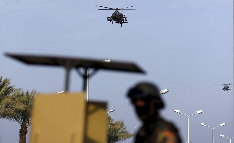 Egyptian military helicopters fly over a republican guard around the congress hall during the Arab Summit in Sharm el-Sheikh, in the South Sinai governorate, south of Cairo, March 28, 2015. Arab League heads of state will hold a two-day summit to discuss 