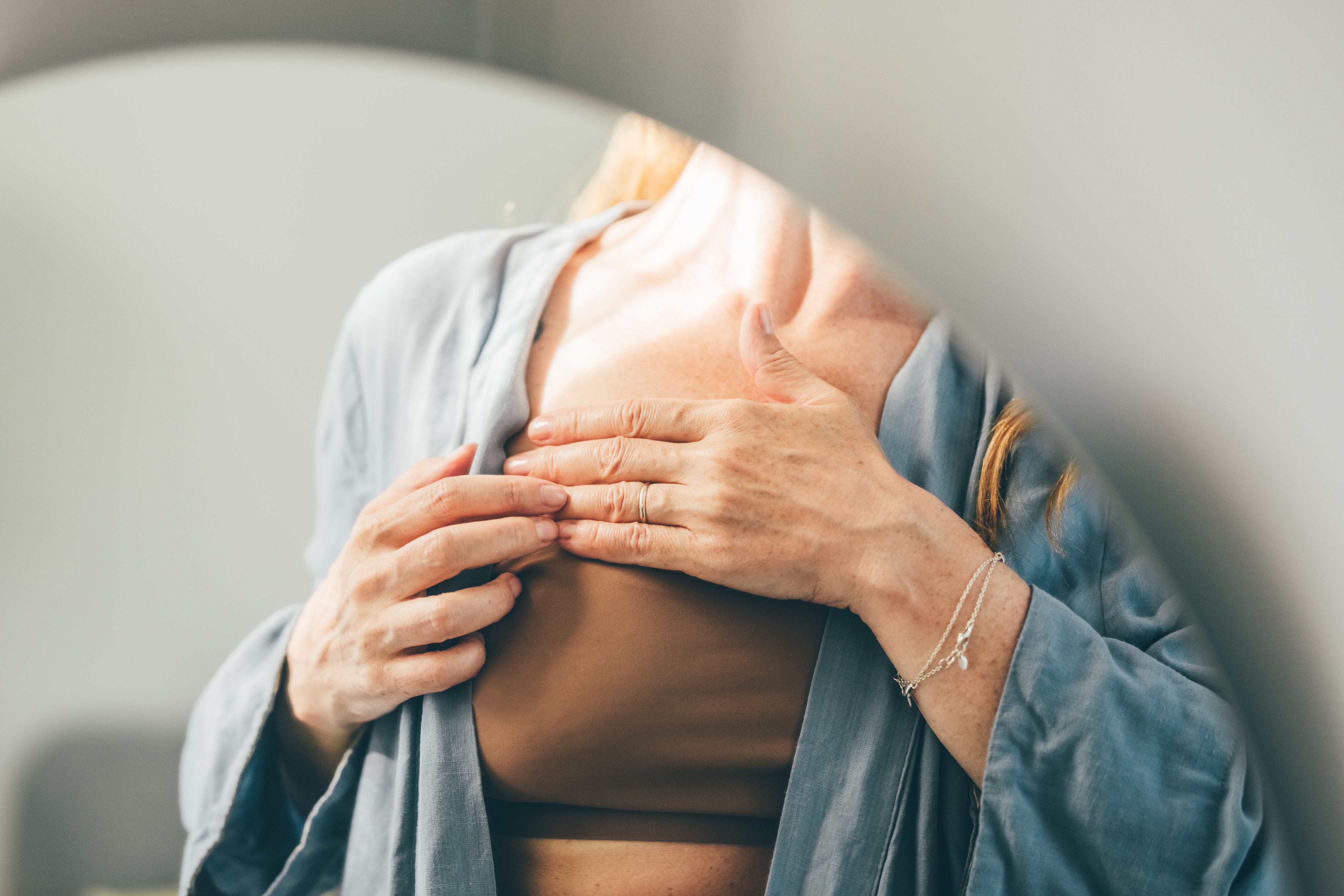 Cropped shot of woman touching her breast for checking cancer awareness.