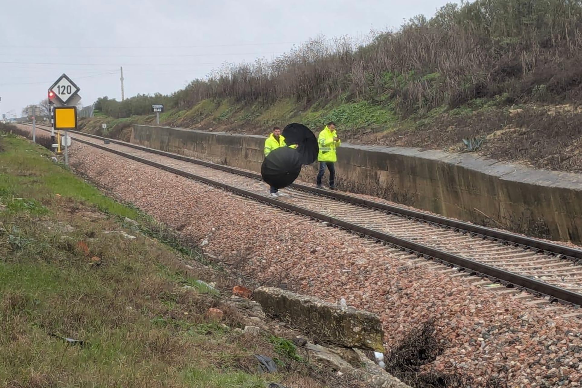ARAHAL (SEVILLA), 25/01/2026.- Técnicos del Administrador de Infraestructuras Ferroviarias (ADIF) revisan el muro en peligro de desprenderse que ha provocado el corte del tráfico ferroviario entre Arahal y Marchena (Sevilla), lo que hace que esté interrumpida la circulación de Media Distancia entre la capital sevillana y Málaga desde la mañana de este domingo. EFE/Fermín Cabanillas
