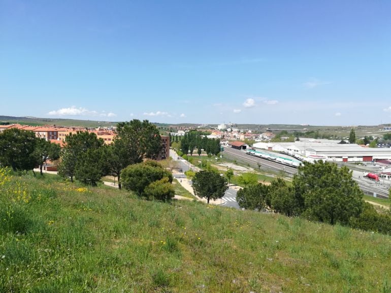 El barrio, a la izquierda. La línea del ferrocarril y la estación de Tejares, a la derecha.