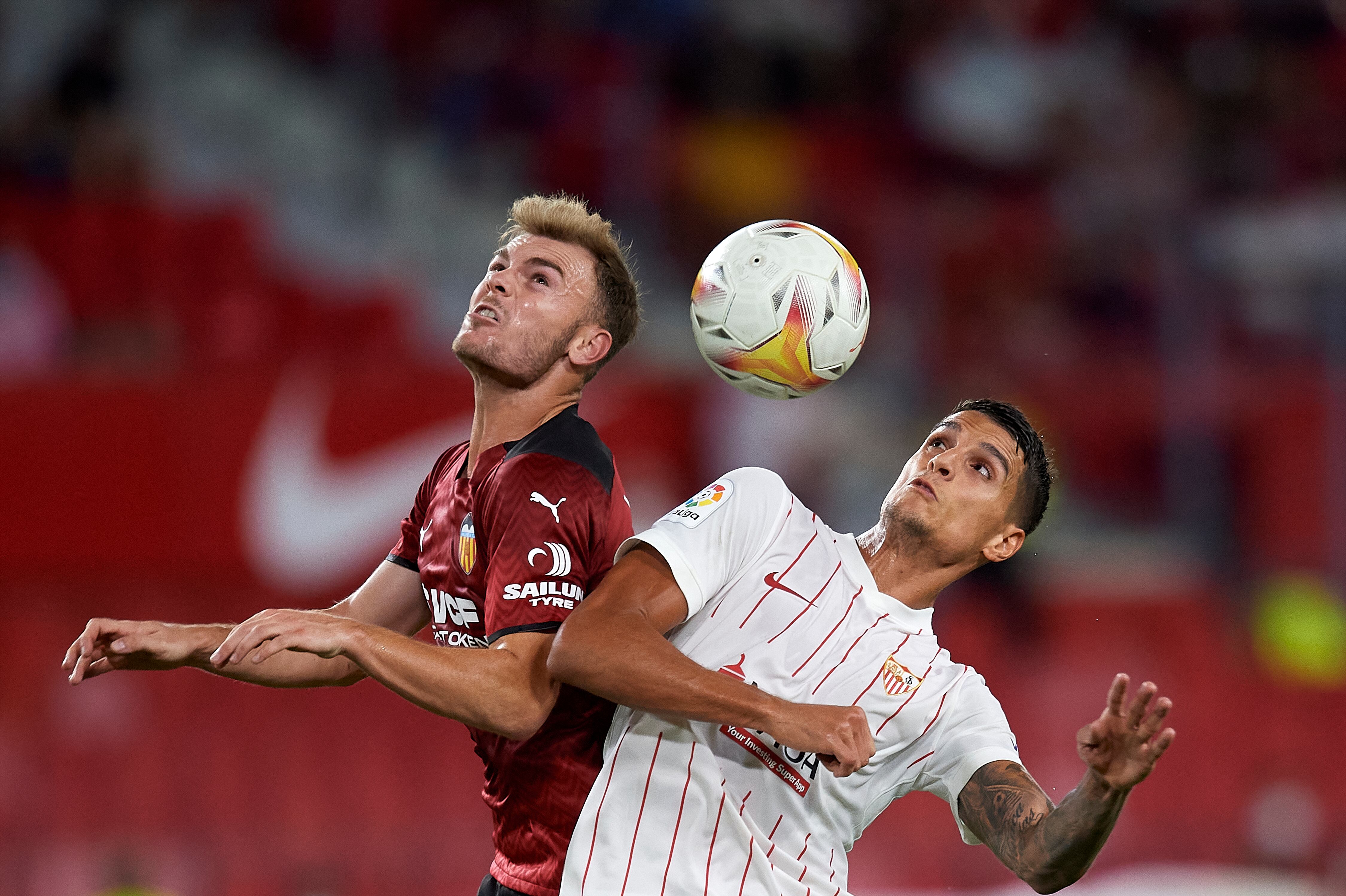 Toni Lato of Valencia and Erik Lamela of Sevilla compete for the ball during the La Liga Santander match between Sevilla FC and Valencia CF at Estadio Ramon Sanchez Pizjuan on September 22, 2021 in Seville, Spain. (Photo by Jose Breton/Pics Action/NurPhoto via Getty Images)