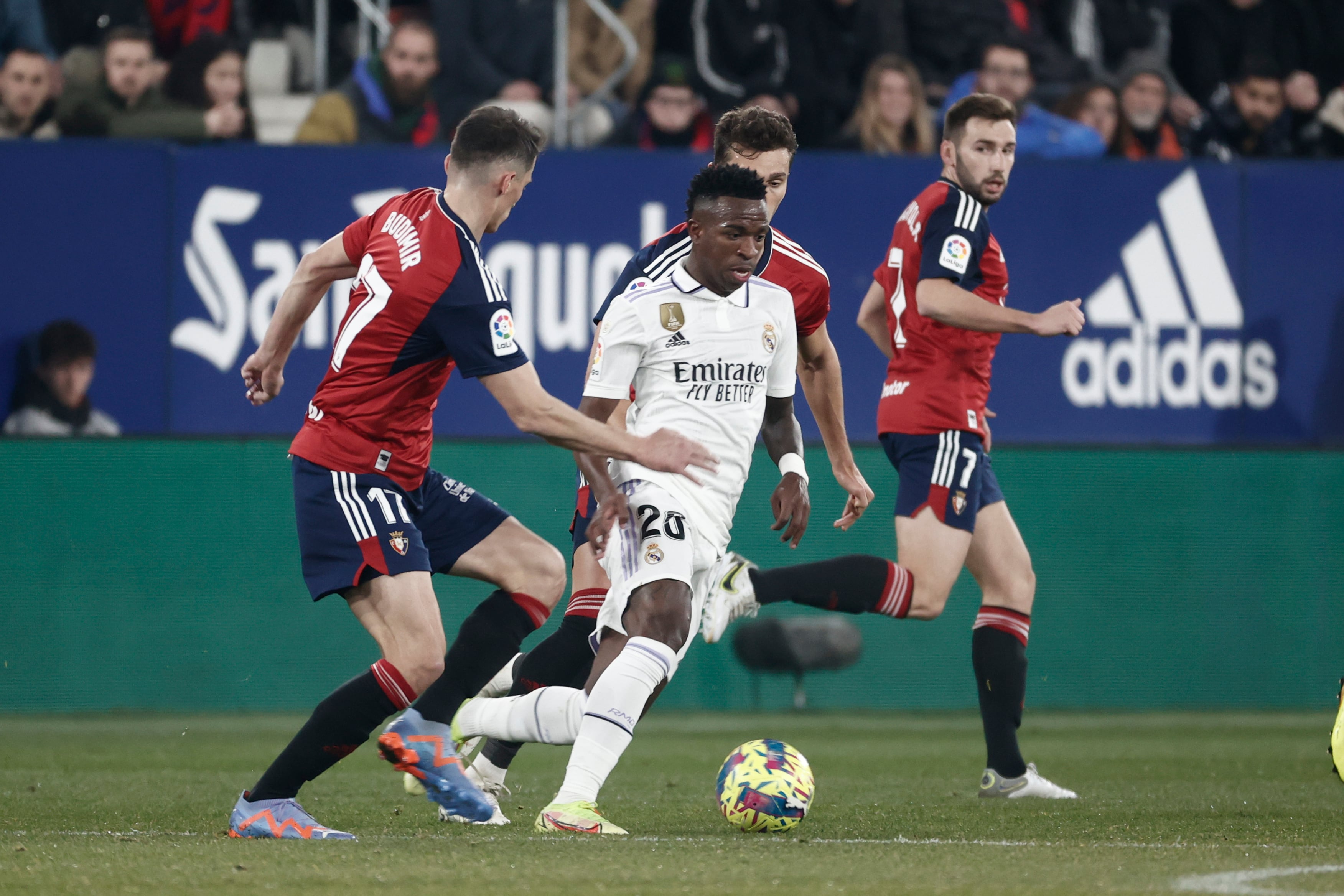 El delantero croata de Osasuna Ante Budimir (i) disputa el balón ante Vinícius Jr (c), delantero brasileño del Real Madrid, durante el encuentro correspondiente a la jornada 22 de primera división