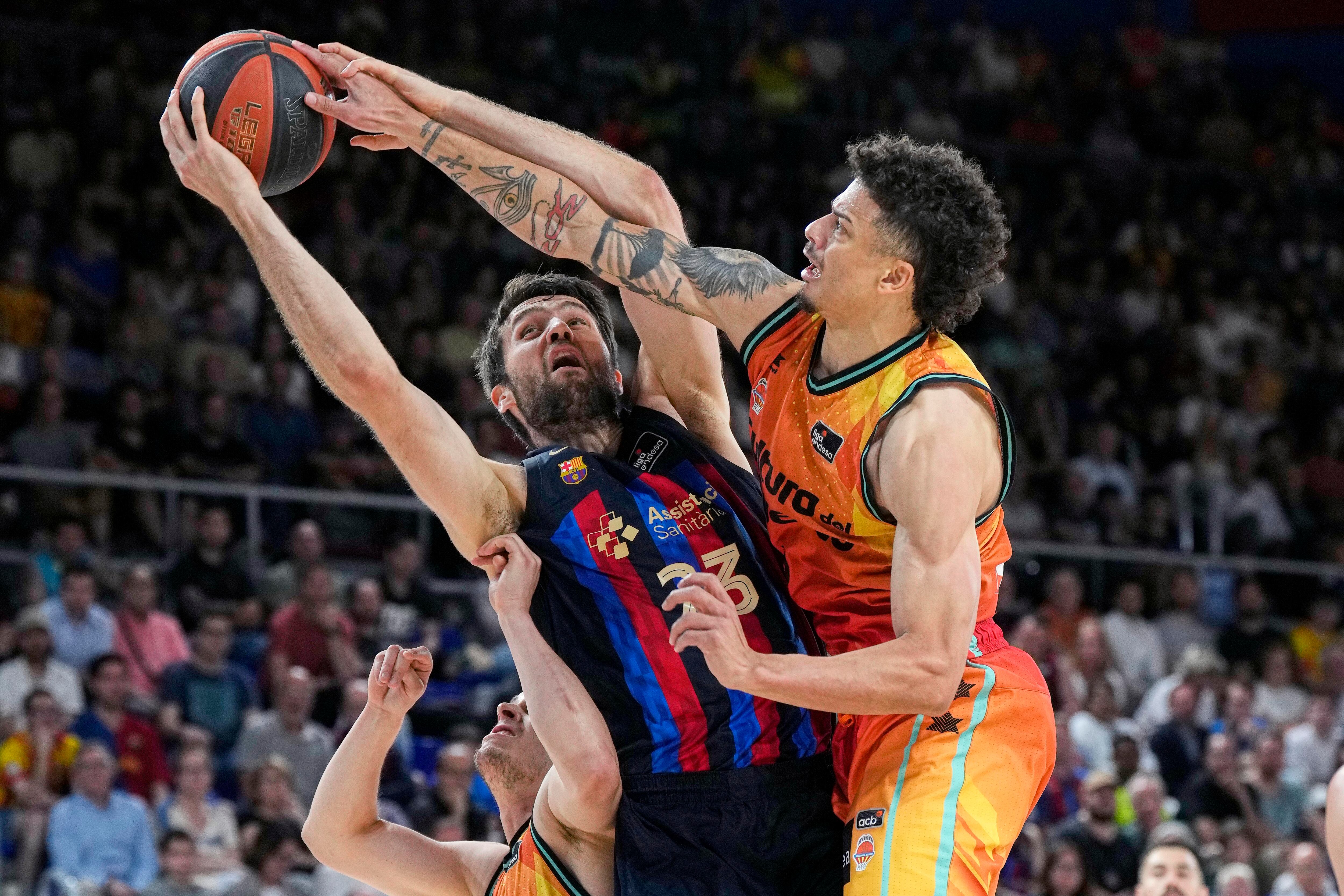 El pivot estadounidense del Barça, Michael &quot;Mike&quot; Tobey, pelea un rebote ante su compatriota, el base de Valencia Basket, Jonah Radebaugh, durante el primer partido de play off disputado hoy lunes en el Palau Blaugrana de Barcelona. EFE/ Alejandro García