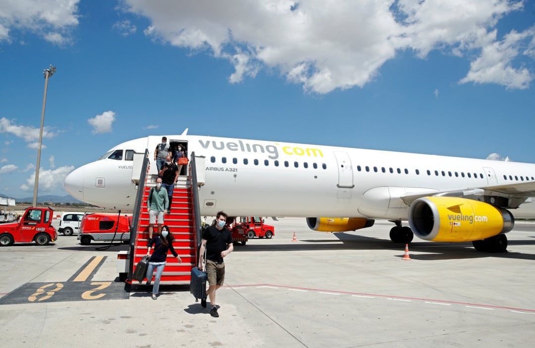 Passengers leave a Vueling plane upon their arrival at Palma de Mallorca airport on the Balearic Islands, Spain, June 13, 2020.