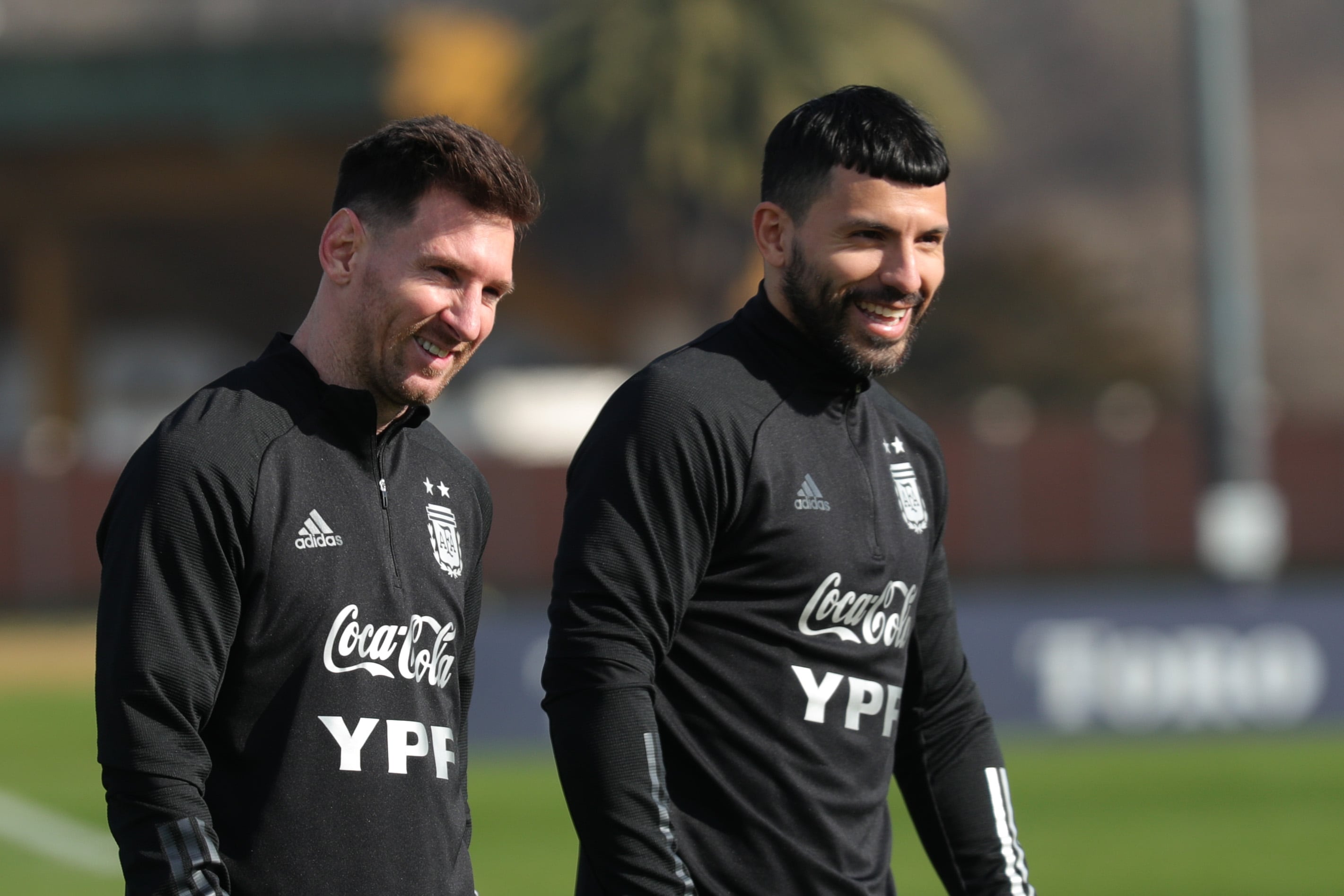 EZEIZA, ARGENTINA - JULY 02: Lionel Messi and Sergio Agüero of Argentina smile during a training session at Julio Humberto Grondona training camp on July 02, 2021 in Ezeiza, Argentina. (Photo by Gustavo Pagano/Getty Images)