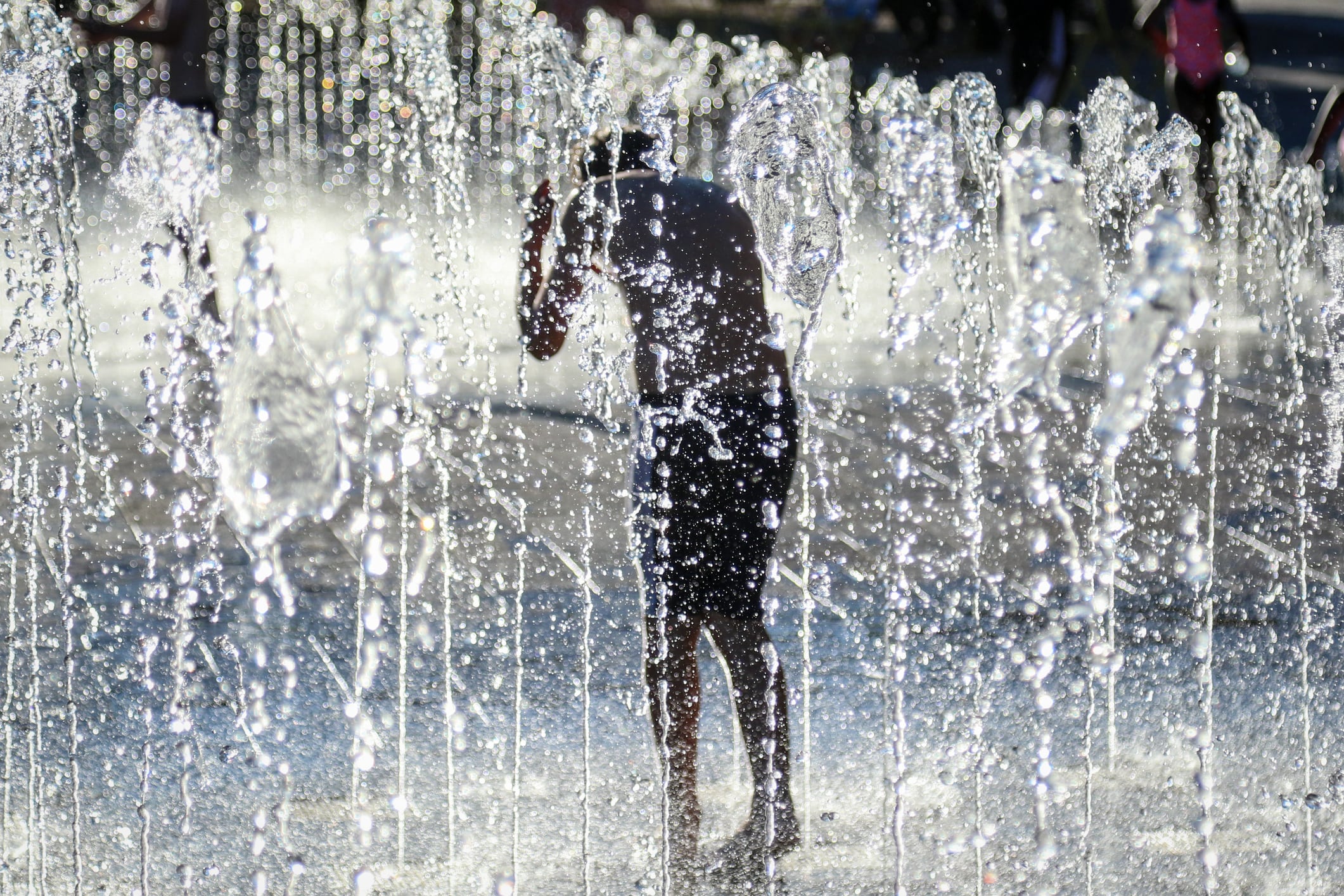 A boy plays in the shower fountain at Granary Square, London