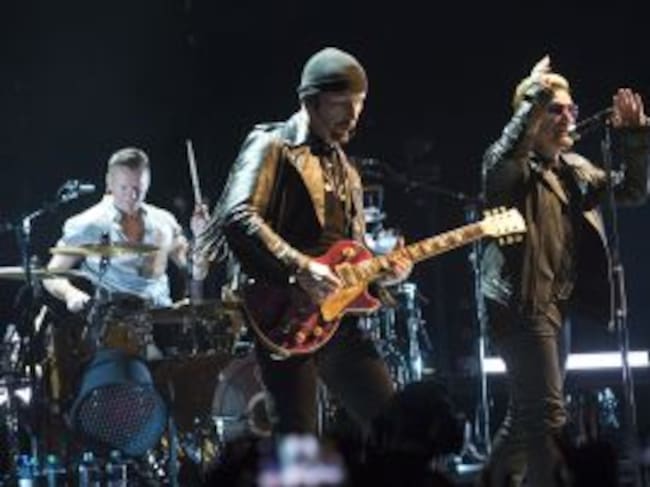 BARCELONA, SPAIN - OCTOBER 05: Larry Mullen Jr., The Edge and Bono of U2 perform on stage at Palau Sant Jordi on October 5, 2015 in Barcelona, Spain. (Photo by Jordi Vidal/Redferns)