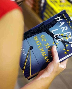 A woman holds a copy of Harper Lee&#039;s book &quot;Go Set a Watchman&quot; before purchasing it inside of a Barnes & Noble store in New York, in this July 14, 2015, file photo. Lee, who wrote one of America&#039;s most enduring literary classics, &quot;To Kill a Mockingbird,&quot; a