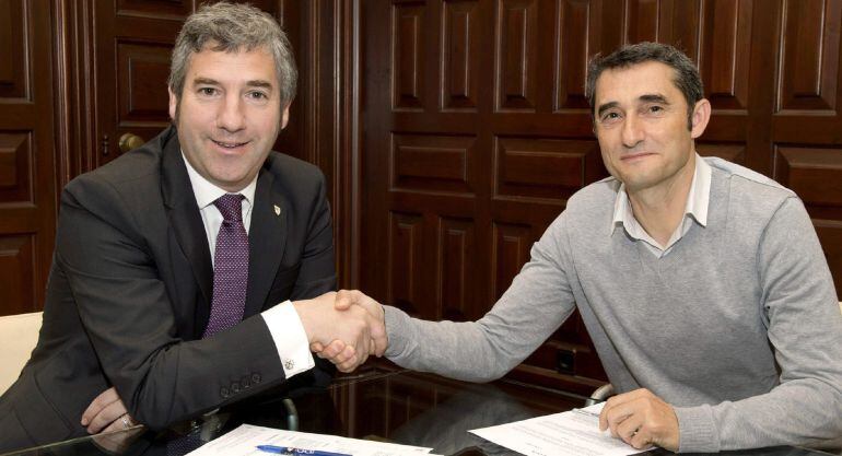 GRA183. BILBAO, 22/05/2015.- Fotografía cedida por el Athletic Club del entrenador del equipo, Ernesto Valverde (d), y el presidente del club, Josu Urrutia, estrechando la mano tras firmar un acuerdo de renovación por una temporada del contrato del técnico que, por lo tanto, permanecerá en la disciplina rojiblanca hasta el 30 de junio de 2016. EFE/***SOLO USO EDITORIAL***