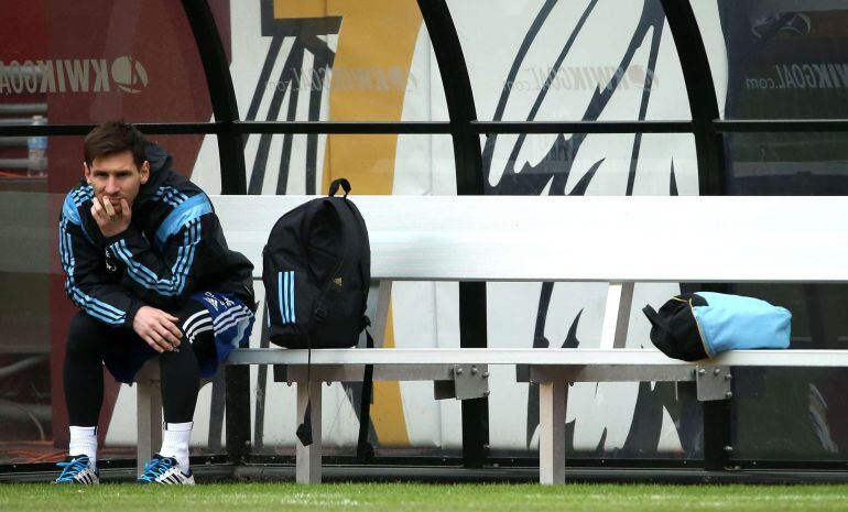 LANDOVER, MD - MARCH 27: Lionel Messi of the Argentinian national soccer team sits on the bench as his teammates practice on the field in preparation to take on El Salvador at FedExField on March 27, 2015 in Landover, Maryland.   Patrick Smith/Getty Image