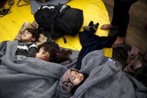 Children sleep on the deck of the rescue ship &quot;Aegis 1&quot;, after a group of about 100 Syrian refugees that landed with rafts on the inhabited islet of Panayia, was retrieved by a Frontex patrol boat and transferred on the &quot;Aegis 1&quot;, near the Greek island of