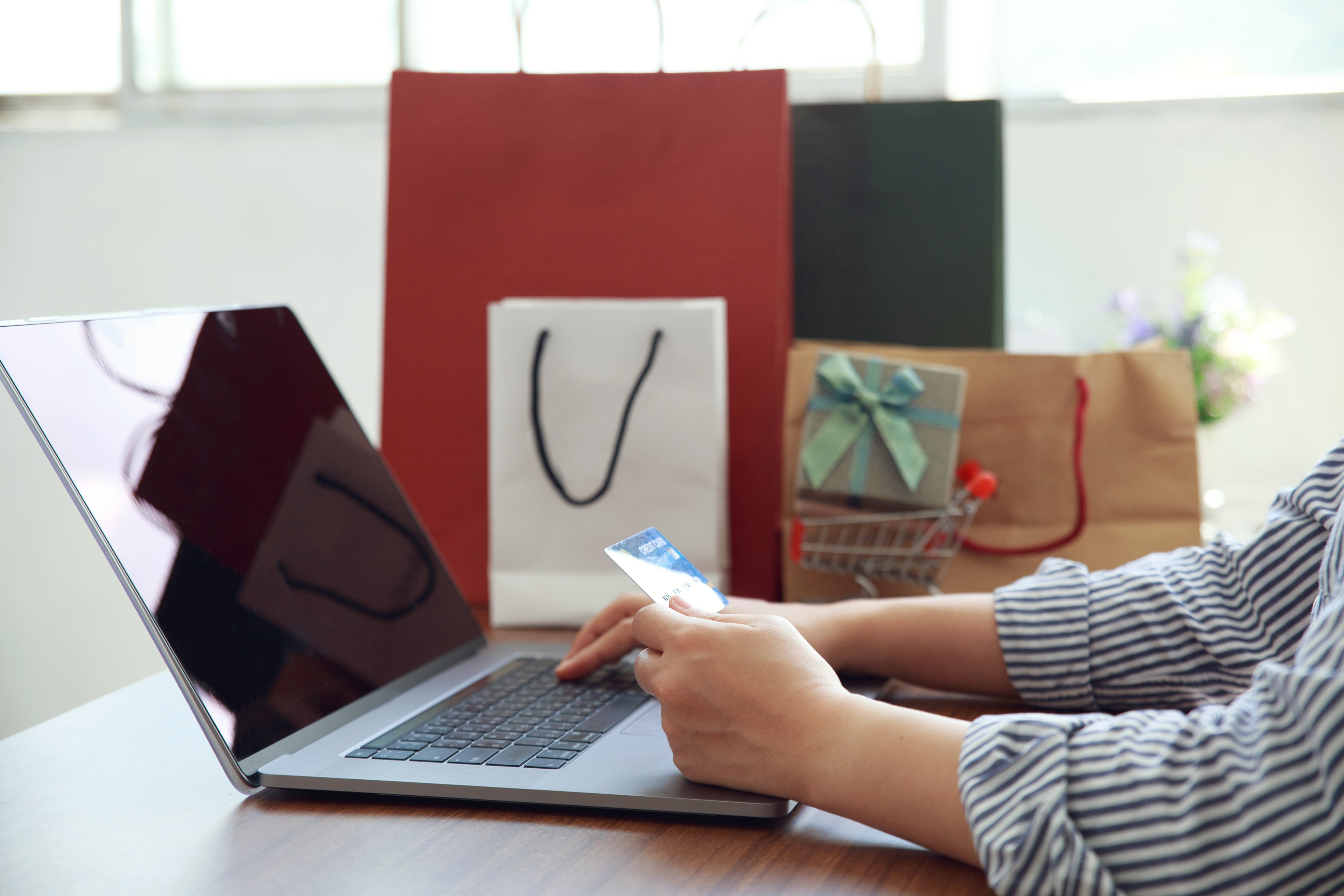 Online payment, Women hands holding credit card and using laptop for online shopping. Black Friday and Cyber Monday Concept