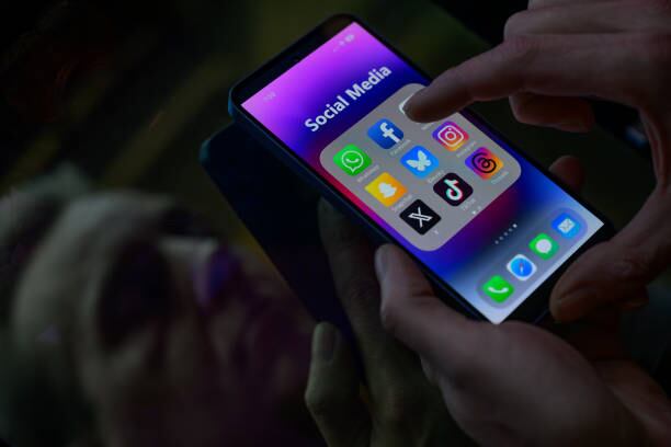 Social media icon applications appear on a mobile phone in this photo illustration in Brussels, Belgium, on March 16, 2025. (Photo by Jonathan Raa/NurPhoto via Getty Images)