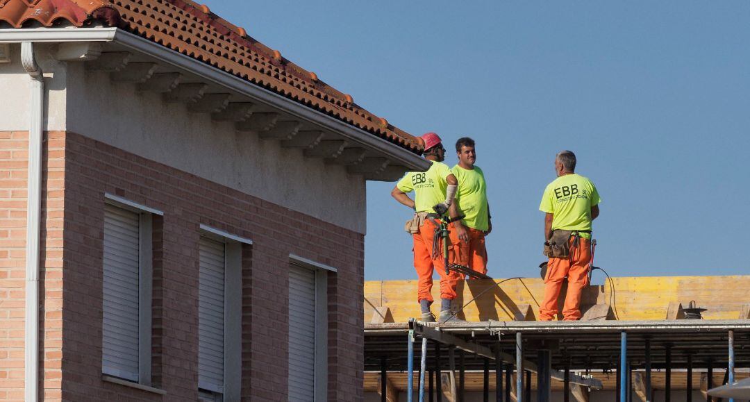 Unos trabajadores durante su jornada laboral en un edificio en construcción.