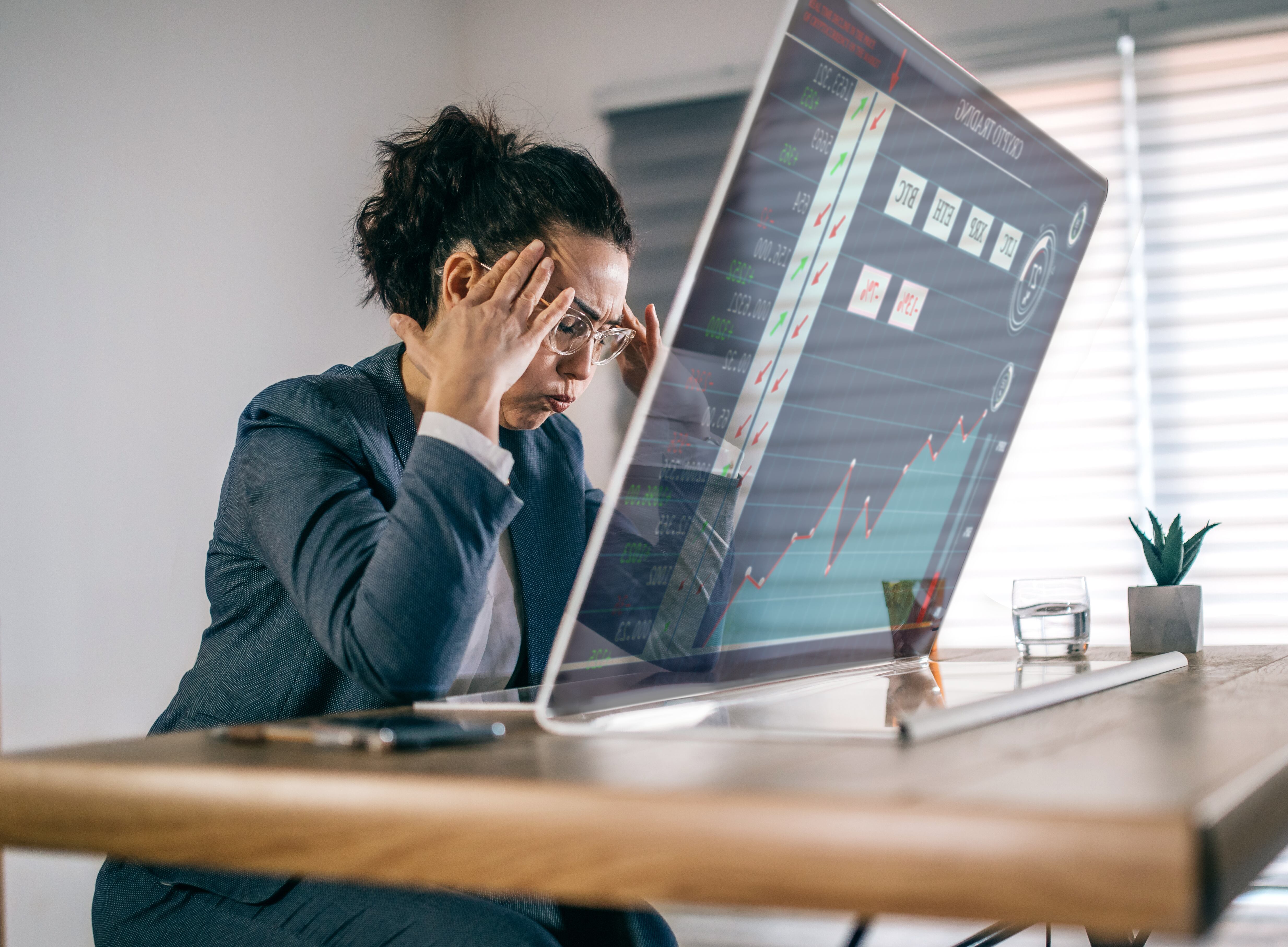 stressed businesswoman feeling desperate on crisis crypto market