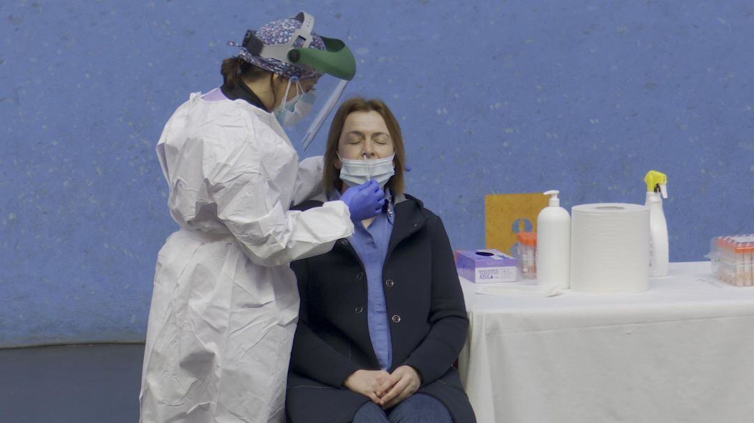 Una sanitaria realiza una prueba PCR a una paciente.