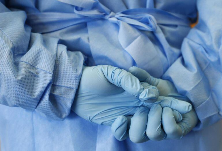 The gloved hands of an army nurse are seen during a demonstration of an isolation chamber for the treatment of infectious disease patients, at the Germany army medical centre, Bundeswehr Clinc, in Koblenz, in this October 16, 2014 file picture. China has contributed over $120 million to fight the spread of the Ebola virus, but its billionaire tycoons - it has more than anywhere outside the United States - have, publicly at least, donated little to the cause, underscoring an immature culture of philanthropy in the world's second-biggest economy. Many big Chinese companies have invested in Africa - China is Africa's leading trading partner - and several operate in West Africa, where Ebola has been at its most lethal, killing close to 5,000 people. To match story HEALTH-EBOLA/CHINA-PHILANTHROPY       REUTERS/Ralph Orlowski/Files (GERMANY - Tags: HEALTH POLITICS BUSINESS DISASTER)