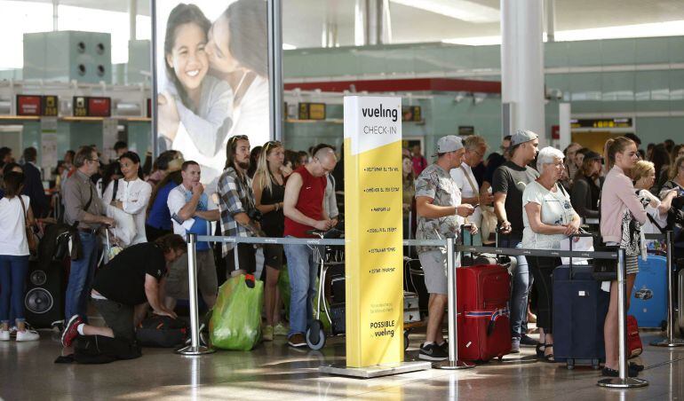 Colas de facturación en los mostradores de Vueling en la Terminal 1 del Aeropuerto de El Prat, en Barcelona. Los mostradores de la aerolínea registran a primeras horas de la mañana menos colas que durante el fin de semana, pese a que la jornada de hoy se 