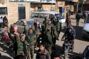 Fighters loyal to Syria&#039;s President Bashar al-Assad celebrate with residents of Nubul and al-Zahraa after breaking the siege of their towns, northern Aleppo countryside, Syria, in this handout picture provided by SANA on February 4, 2016. REUTERS/SANA/Han