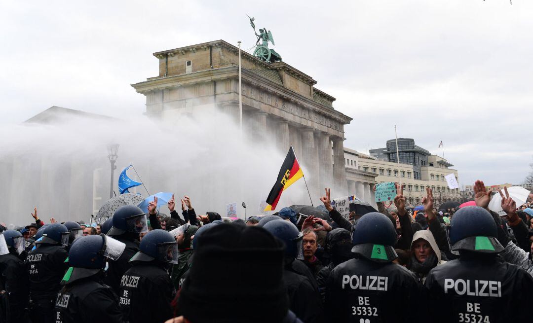 Riot police uses water cannons to break up a demonstration against German coronavirus restrictions