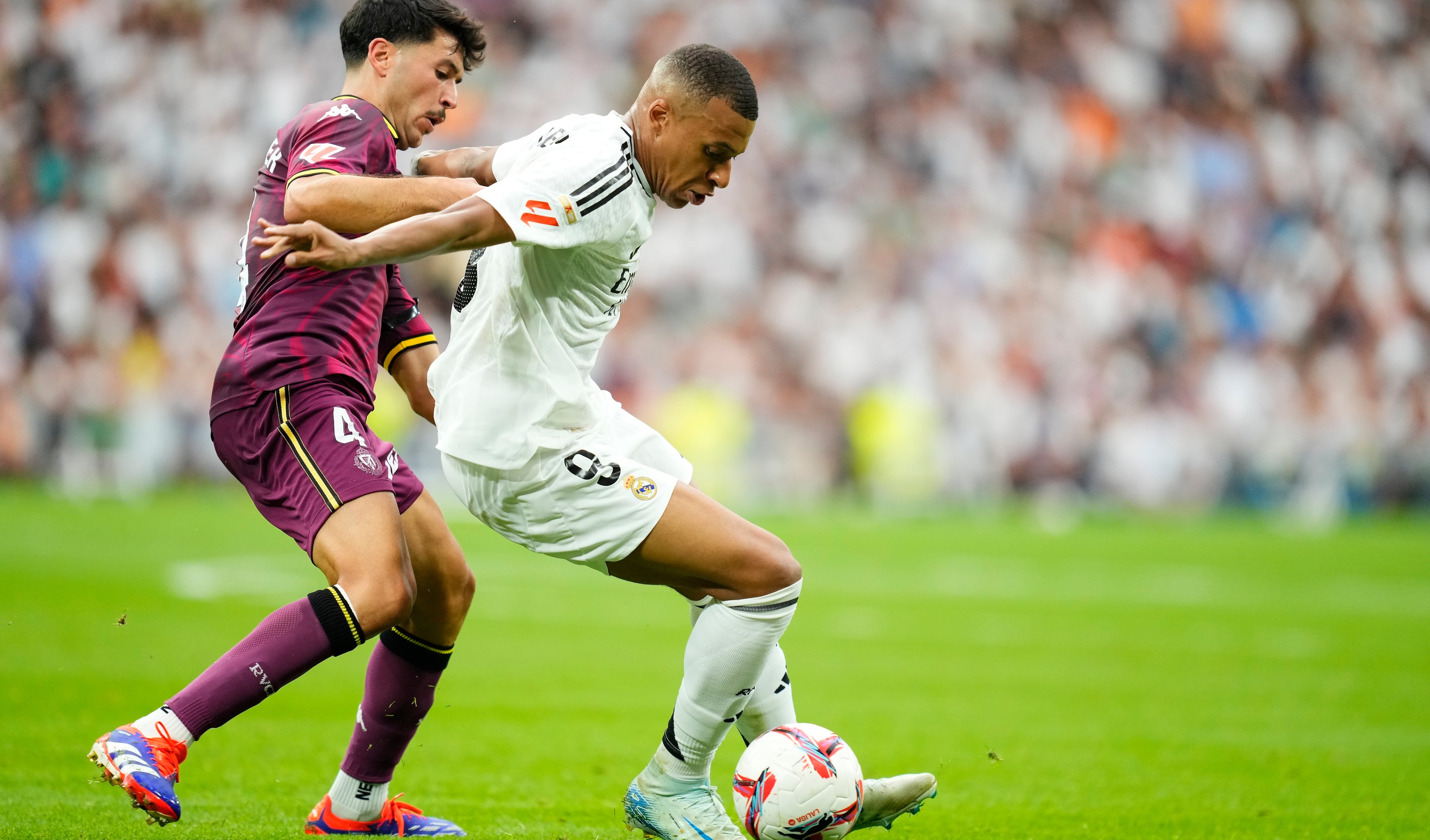 Kylian Mbappe centre-forward of Real Madrid and France and Victor Meseguer central midfield of Valladolid and Spain compete for the ball during the La Liga match between Real Madrid CF and Real Valladolid CF at Estadio Santiago Bernabeu on August 25, 2024 in Madrid, Spain. (Photo by Jose Breton/Pics Action/NurPhoto via Getty Images)