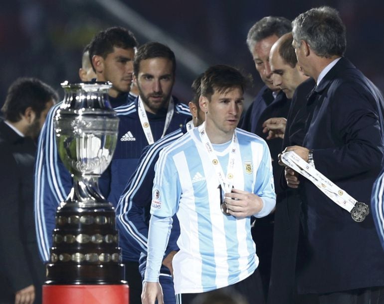 Argentina&#039;s Lionel Messi walks past the trophy after losing to Chile in the Copa America 2015 final soccer match at the National Stadium in Santiago, Chile, July 4, 2015. REUTERS/Marcos Brindicci