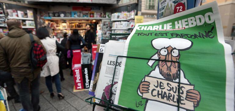 ATTENTION EDITORS - THIS PICTURE MAY OFFEND SOME PEOPLE     People queue for the new issue of satirical French weekly Charlie Hebdo entitled &quot;Tout est pardonne&quot; (&quot;All is forgiven&quot;), which shows a caricature of Prophet Mohammad, at a kiosk in Nice January