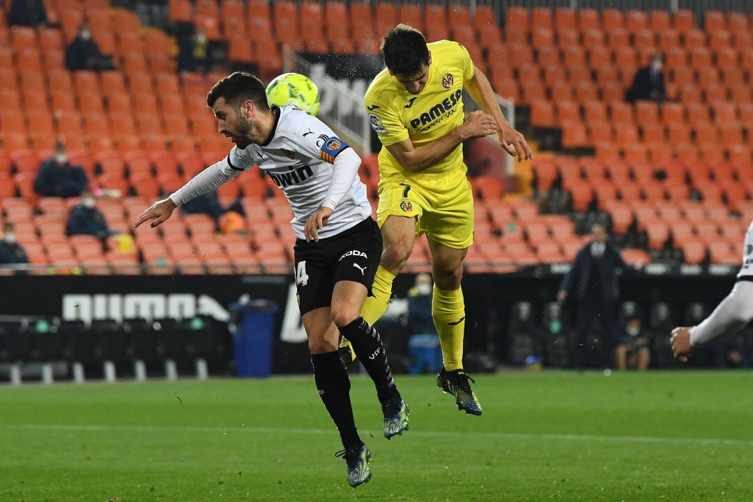 VALENCIA, SPAIN - MARCH 05: Gerard Moreno of Villareal heads against the arm of Jose Gaya of Valencia which lead to a penalty being awarded after a review by VAR during the La Liga Santander match between Valencia CF and Villarreal CF at Estadio Mestalla 