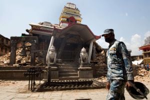 A Nepalese policeman walks past the destroyed temple of Rato Machindranath Bahan at Bungamati village, in Lalitpur district of the Kathmandu valley on May 2, 2015. Nepal has ruled out the possibility of finding more survivors buried in the rubble from a m