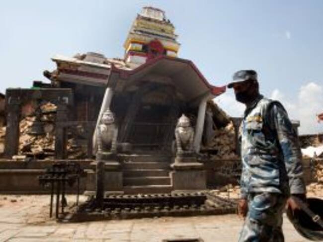 A Nepalese policeman walks past the destroyed temple of Rato Machindranath Bahan at Bungamati village, in Lalitpur district of the Kathmandu valley on May 2, 2015. Nepal has ruled out the possibility of finding more survivors buried in the rubble from a m
