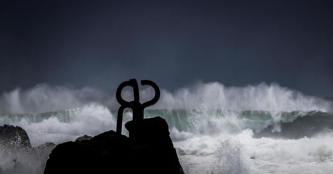 Una ola rompe junto a la escultura el Peine del Viento, de Eduardo Chillida, en San Sebastián.