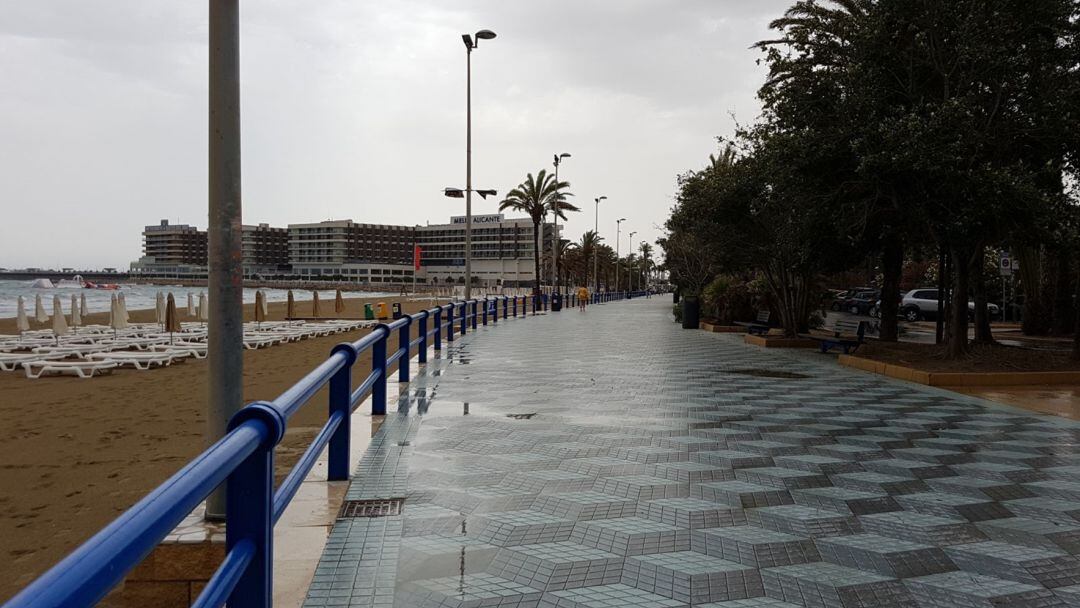 El paseo de la Explanada y la playa del Postiguet vacíos, en un día de lluvia.